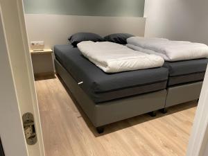 a bed with two white pillows on top of it at Apartment in Groede near the Beach in Groede