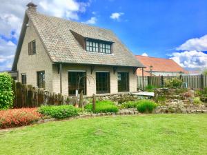 a house with a fence and a yard at Holiday Home in Groede near Sandy Beach in Groede