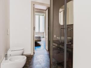 a bathroom with a toilet and a sink at Apartment in Giarre near Mount Etna in Giarre +28 photos