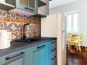 a kitchen with a sink and a refrigerator at Apartment in Giarre near Mount Etna in Giarre