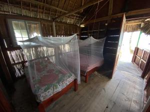 Postel nebo postele na pokoji v ubytování Cabaña privada en las islas de San blas Aroma
