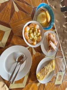 a table with plates and bowls of food on it at DANG dang Balbago Beach in El Nido +56 photos