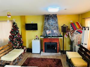 a living room with a christmas tree and a fireplace at Quinta Los Ángeles in Riobamba