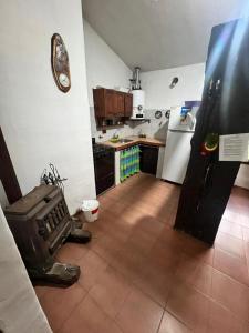 a kitchen with a refrigerator and a tile floor at Mar y Sierras in La Paz