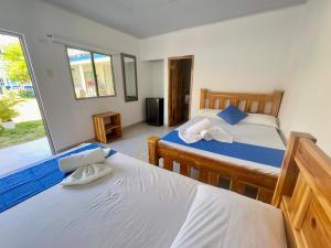 Voodi või voodid majutusasutuse Tintipan Hotel toas