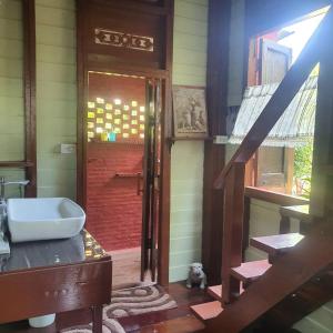 a bathroom with a stairs leading to a door at Sandy Lake 2012 in Kaeng Krachan