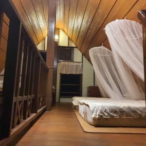 a room with two beds with mosquito nets in it at Sandy Lake 2012 in Kaeng Krachan