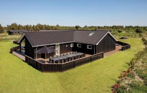 an overhead view of a black house with a lawn at Stunning Home In Jerup With Sauna in Jerup