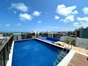 a large swimming pool on the roof of a building at Luxury Flat dos Sonhos - Edificio Compact Tambau in João Pessoa