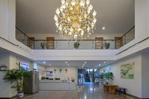 a large chandelier hanging from the ceiling in a building at Floral design Longhu Mountain Residence in Caijia