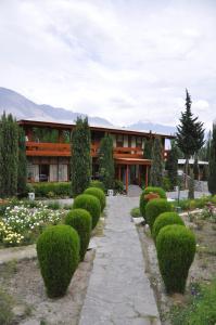 a building with a row of hedges in front of it at Gilgit Serena Hotel in Gilgit