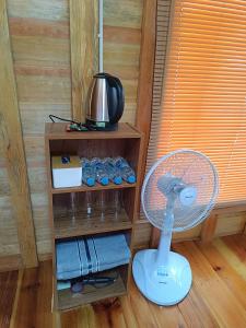 a fan sitting in a room with a wooden floor at อินทนนท์สุขุมทิพย์ โฮมสเตย์ Inthanonsukhumtiphomestay in Ban Yang +28 photos