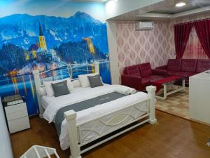 a bedroom with a bed and a painting on the wall at Athallah Homestay Syariah in Lampung