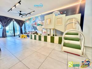 a childrens room with a bunk bed and a slide at Atlantis Residences Melaka by HeyStay Management in Melaka