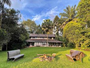 a house sitting in the middle of a green yard at Temuku Pupuan Farmstay in Padangan