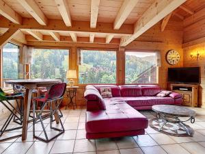 a living room with a couch and a table at Chalet haut de gamme 8 pers à La Clusaz avec Wifi et parking - FR-1-818-74 in La Clusaz