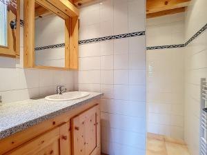 a bathroom with a sink and a mirror at Chalet haut de gamme 8 pers à La Clusaz avec Wifi et parking - FR-1-818-74 in La Clusaz +7 photos