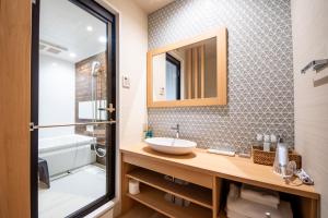 a bathroom with a sink and a mirror at Hotel Naranohamori in Nara