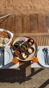 a tray of food on a table with eggs and bread at AYLA bidiyah in Badīyah