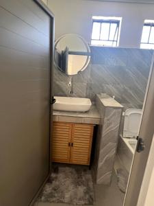 a bathroom with a sink and a mirror at Hebergement beau bassin in Beau Bassin