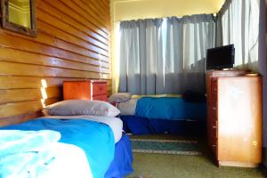 Ένα ή περισσότερα κρεβάτια σε δωμάτιο στο Big Tree Lodge Methven