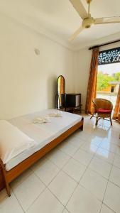 a bedroom with a large bed and a window at Relax Home in Sri Jayewardenepura Kotte