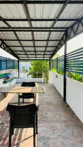 a patio with a table and chairs on a roof at Relax Home in Sri Jayewardenepura Kotte