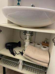 a bathroom shelf with a sink and a towel at Agnes - Romance in city II. in Prague +17 photos