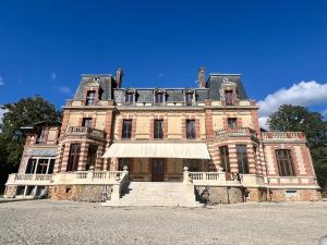 an old brick building with stairs in front of it at Château de Crenille -Appartements in Chaumes-en-Brie +6 photos