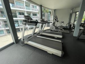 a gym with two treadmills and two exercise bikes at Laguna Beach 1 Condo&Resort Pattaya Bey Aey in Jomtien Beach