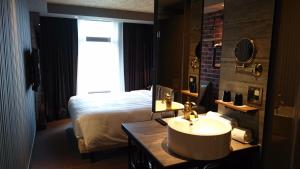 Postel nebo postele na pokoji v ubytování City Suites - Kaohsiung Pier2