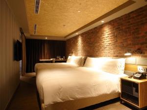 Postel nebo postele na pokoji v ubytování City Suites - Kaohsiung Pier2
