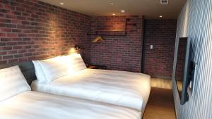 Postel nebo postele na pokoji v ubytování City Suites - Kaohsiung Pier2