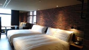 Postel nebo postele na pokoji v ubytování City Suites - Kaohsiung Pier2
