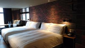 Postel nebo postele na pokoji v ubytování City Suites - Kaohsiung Pier2