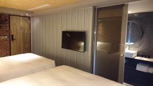 Postel nebo postele na pokoji v ubytování City Suites - Kaohsiung Pier2