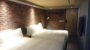 Postel nebo postele na pokoji v ubytování City Suites - Kaohsiung Pier2