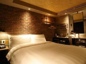 Postel nebo postele na pokoji v ubytování City Suites - Kaohsiung Pier2