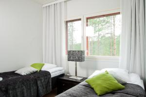 Postel nebo postele na pokoji v ubytování Haapala Suites entinen IIDA Vuokatti