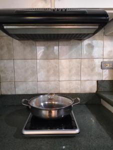 a pan sitting on top of a stove in a kitchen at Chic Haven in Manila +9 photos