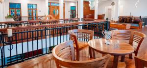 a restaurant with tables and chairs and a pool at Tea Hills Lake in Hatton