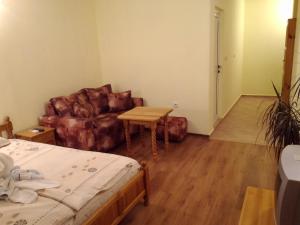 a room with a bed and a couch and a table at Guest House Diamant in Sozopol