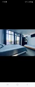a bedroom with a large bed with a window at La Belle Vie in Vartop