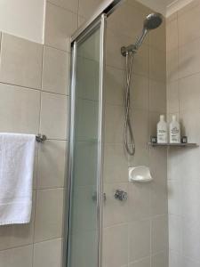 a shower with a shower head in a bathroom at Poppies Clunes in Clunes