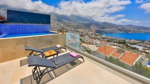 a balcony with a view of the water and mountains at Seaview Luxury Apartment - 6839 in Kalkan