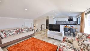 a living room with a couch and a kitchen at Seaview Luxury Apartment - 6839 in Kalkan