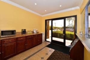 a kitchen with a counter with a microwave and a window at Americas Best Value Inn & Suites Los Angeles Downtown SW in Los Angeles