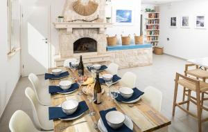 a dining room with a table and a fireplace at Villa Sea Escape in Brusje