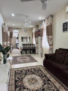 a living room with a couch and a dining room at Adawiyah Guest House, Gambang in Gambang