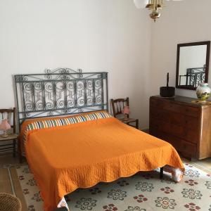 a bedroom with an orange bed and a dresser at Terra del Sole Ribera in Ribera